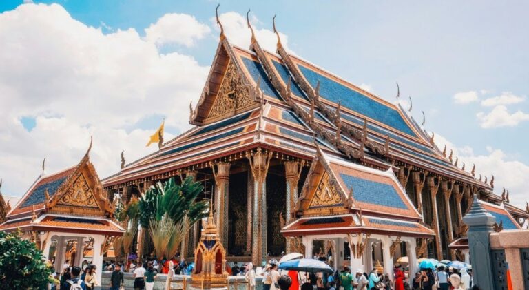 Rua movimentada de Bangkok com turistas e templos ao fundo — a Tailândia é um dos destinos mais seguros do Sudeste Asiático